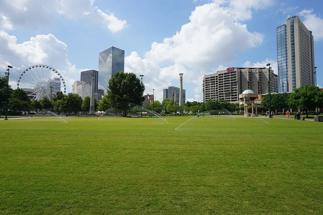 Centennial Olympic Park lawn with the Atlanta skyline and SkyView wheel — stock photo placeholder
