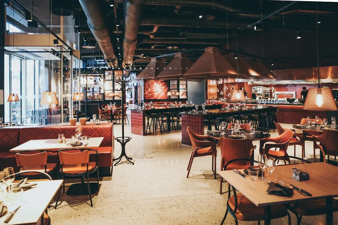 Warm restaurant interior with comfortable seating — stock photo placeholder